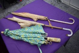 Two 1940s/50s umbrellas having celluloid handles, also included is a vintage parasol having been