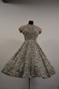 A vibrant 1950s Horrockses cotton day dress, having full skirt, side metal zip and buttons to
