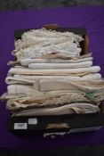 A box full of vintage and antique table linen and similar, some edged in crotchet, others with