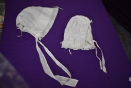 Two antique white cotton bonnets.