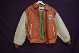 A vintage collectable Planet Hollywood bomber style leather jacket in brown and tan colour way,