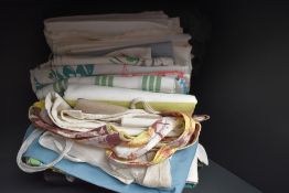 A miscellany of textiles to include mid century aprons, A pyjama case, brightly printed mid