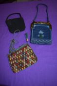 Two late 19th/ early 20th century needlepoint bags and a 1930s black crepe evening bag.
