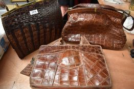 Three vintage reptile skin handbags, two with claps top fastenings and the third with a metal zip