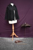 A beaded black Victorian cape sold alongside two brown silk parasols, AF damage to both.