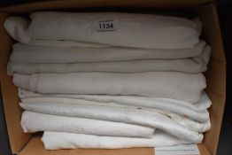 A collection of around ten vintage and antique damask table cloths.