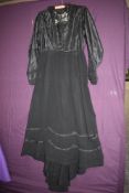 A late 19th/early 20th century silk and muslin dress having lace collar, cuff and insert to