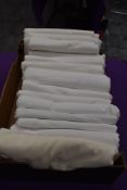 Around fifteen vintage and antique white bed sheets.