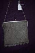 A circa 1920s chain bag lined having clasp fastening with blue glass detail.