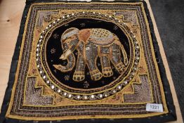 A heavily embellished Indian panel having raised elephant to centre, sequins and glass beadwork.