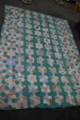 A late 19th early 20th century patchwork quilt using hexagons in eye catching colours and