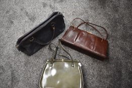 Three vintage handbags including metallic green vinyl clasp top bag, reptile skin and navy blue