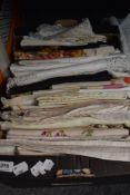 A selection of vintage and antique table linen, mostly embroidered and a few having bright printed