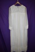 A Late 1960s wedding dress having sheer sleeves.