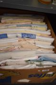 A mixed collection of predominantly mid 20th century and earlier table linen, bright rayon and