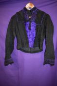 A Victorian bodice having purple silk accents to front and cuffs.