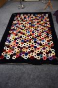 A large 19th century quilt using a combination of colourful velvet, silk and other fabrics having