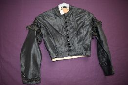 A Victorian black silk bodice having black glass buttons to front and beading and braiding to