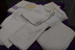 A box of vintage and antique damask table cloths and napkins.