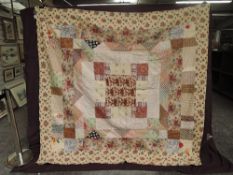 A stunning late Victorian patchwork coverlet, backed in cream cotton, using vibrant floral cottons