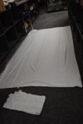 A lace bordered linen table cloth and an incredibly large damask example.