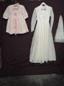 A 1960s lace wedding dress having full length sleeves, gathered bodice with bead detailing and