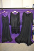Three vintage 1960s and 1970s black dresses.