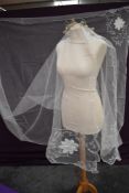 A circa 1930s tulle veil and head dress having wax flower and diamante details.