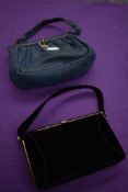 Two 1950s clasp fastening framed hand bags, one of black velvet the other navy leather.