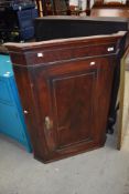 A Victorian corner cupboard with mahogany case