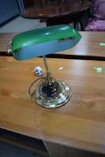 A reproduction brass desk lamp having green glass shade