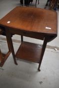 An Edwardian mahogany occasional table having drop flaps