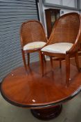 A 20th century Art Deco design extending circular pedestal table and rattan chair set of six