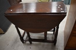 A nice quality period style reproduction oak gateleg dining table