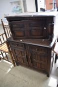 A 20th century dark oak sideboard having under and over cupboard with two drawers