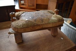A Camel or foot stool having tooled leather top