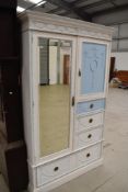 A 20th century painted pine shabby chic style wardrobe and drawer unit in a French style