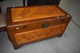 An Oriental Chinese camphor wood bedding box having carved decoration