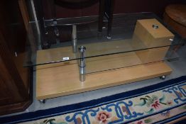 A 20th century modern laminate and glass coffee table