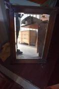 An early 20th Century mahogany wall mirror having applique decoration, approx. 80 x 54cm