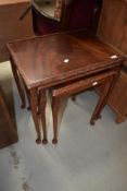 A reproduction mahogany nest of three tables in the period style