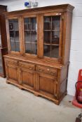 A reproduction golden oak (Titchmarsh & Goodwin or similar) period style dresser having glazed top