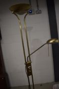 A modern standard lamp having polished brass effect