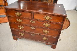 A Georgian mahogany chest of two short over three long drawers, having brass handles and bracket