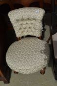A Victorian low seat nursing chair having later upholstery