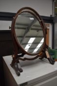 A Regency design toilet or dressing table mirror having mercury glass in mahogany frame with a