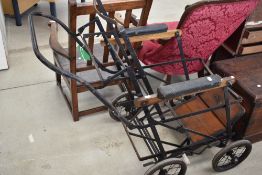 An Edwardian invalid carriage or wheel chair metal frame with rubber wheels