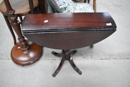 A reproduction Regency mahogany occasional table having drop flaps