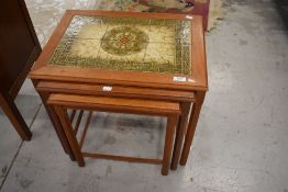 A vintage nest of three tile top occasional tables