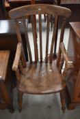 A traditional stained frame kitchen armchair